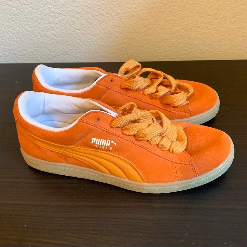 Orange suede pumas